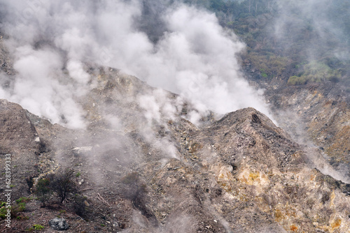 Wisps of smoke around the crater scattered rocks