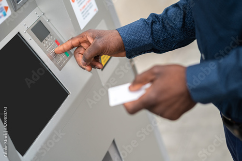 Close up picture of a man retrieving money from ATM