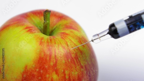 Poison Injected into Apple from Syringe by Person in Blue Gloves