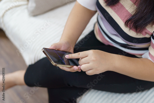 Woman hand using smartphone for checking social media or  woman reading ebook on screen.