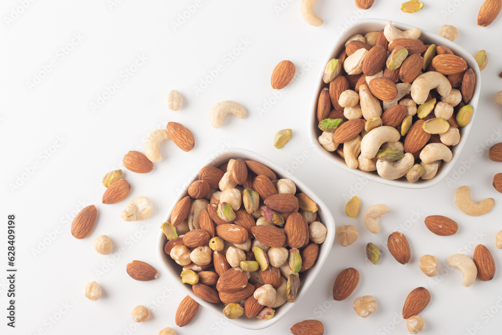Large assortment of nuts in different bowls on stone table. Large assortment of nuts in different bowls on stone table.