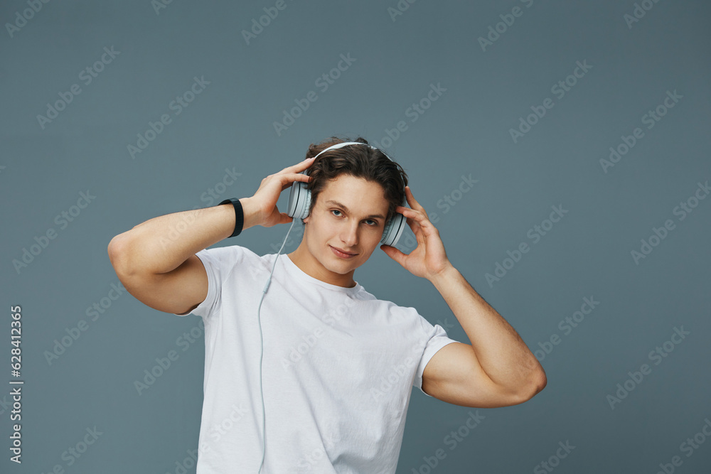 man copy t-shirt studio earphones portrait happy young space music listen lifestyle man copy t-shirt studio earphones portrait happy young space music listen lifestyle