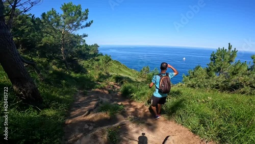 A young man walking the Monte Ulia trail that goes from Pasajes San Pedro to San Sebastian in the province of Gipuzkoa photo