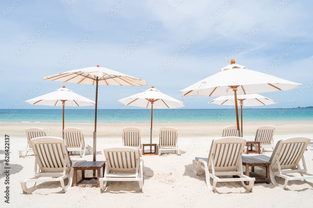 lounge chairs with sun umbrella on a beach