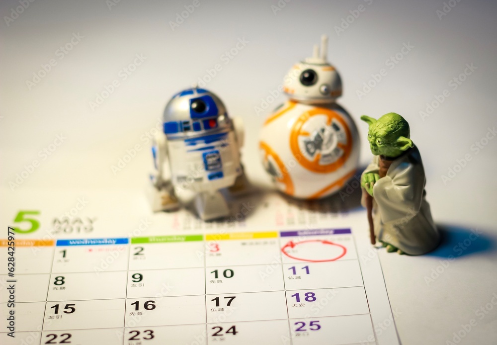 Naklejka premium TOKYO, JAPAN - APRIL 22, 2019 - Star Wars Figures (Yoda, BB8 & R2-D2) on a calendar sheet looking at May the 4th