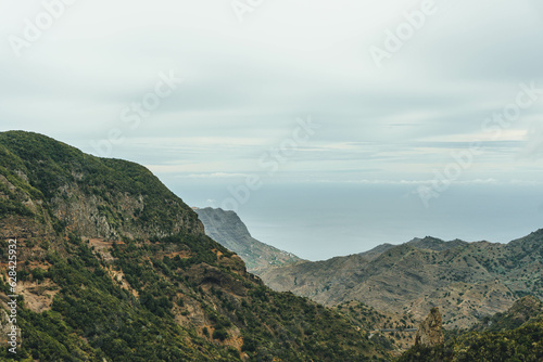 View of rocky steep volcanic mountains valley and sea on atlantic island