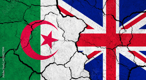 Flags of Algeria and United Kingdom on cracked surface - politics, relationship concept
