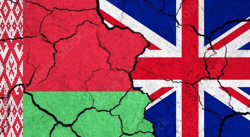 Flags of Belarus and United Kingdom on cracked surface - politics, relationship concept