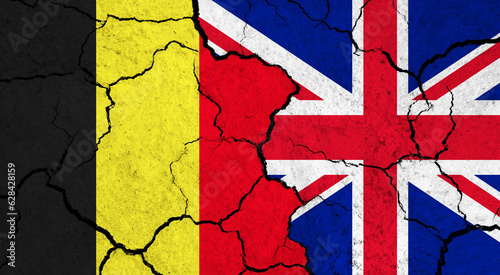 Flags of Belgium and United Kingdom on cracked surface - politics, relationship concept