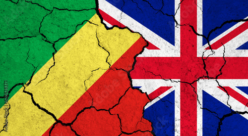 Flags of Congo and United Kingdom on cracked surface - politics, relationship concept