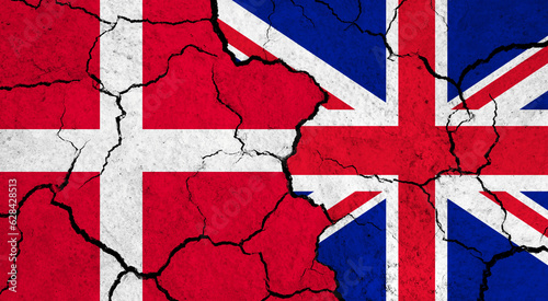 Flags of Denmark and United Kingdom on cracked surface - politics, relationship concept