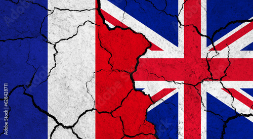 Flags of France and United Kingdom on cracked surface - politics, relationship concept