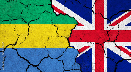 Flags of Gabon and United Kingdom on cracked surface - politics, relationship concept