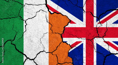 Flags of Ireland and United Kingdom on cracked surface - politics, relationship concept