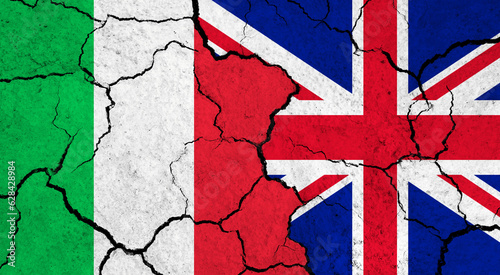 Flags of Italy and United Kingdom on cracked surface - politics, relationship concept