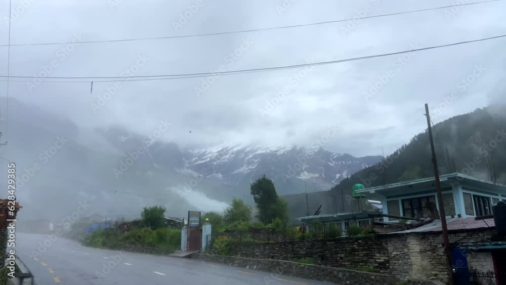 Snowy mountain tops. Mountains in dense fog. Rainy road in the mountains. Road in Nepal. Cloudy sky. Snow Snowy mountain tops. Mountains in dense fog. Rainy road in the mountains. Road in Nepal. Cloudy sky. Snow