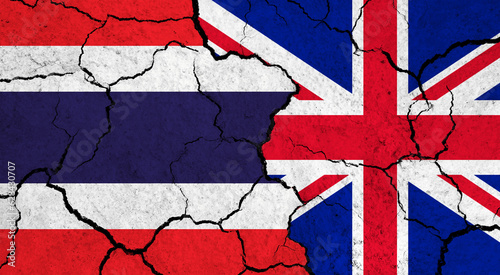 Flags of Thailand and United Kingdom on cracked surface - politics, relationship concept