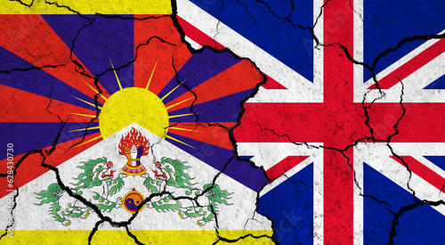Flags of Tibet and United Kingdom on cracked surface - politics, relationship concept