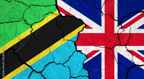 Flags of Tanzania and United Kingdom on cracked surface - politics, relationship concept