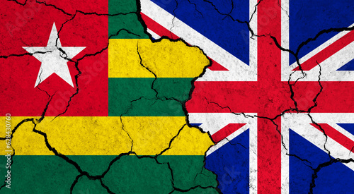 Flags of Togo and United Kingdom on cracked surface - politics, relationship concept