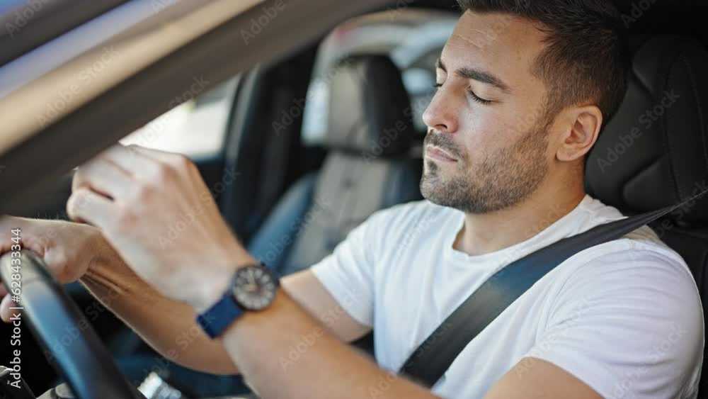 Young hispanic man tired driving car yawning at street Young hispanic man tired driving car yawning at street