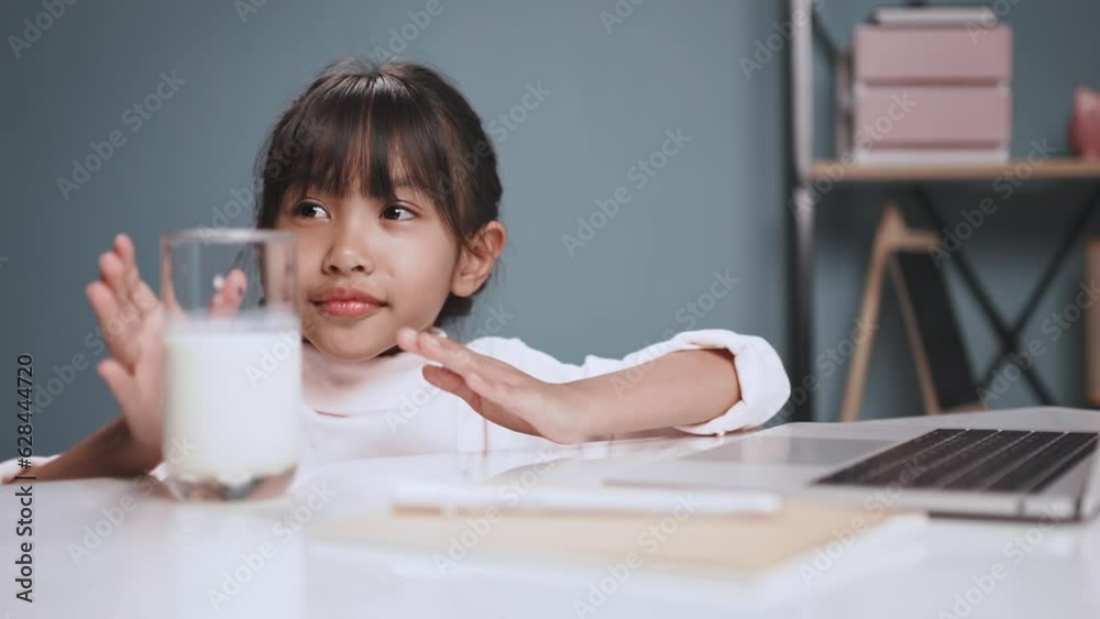 A little girl drinking fresh milk in clear glass. A little girl drinking fresh milk in clear glass.
