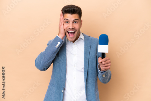 Fényképezés Young caucasian TV presenter man isolated on white background with surprise and