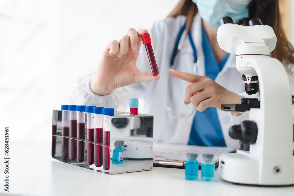 Fototapeta premium Lab work, Doctor holds a test tube takes the test from a test tube in analysis, blood, DNA, test tube stand.