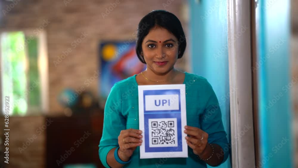 An Indian woman displays QR code, embracing the ease and speed of online payments, a step towards digital empowerment.