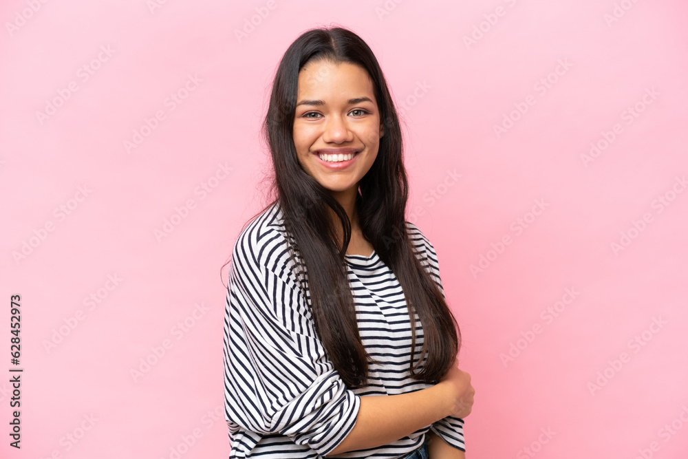 Fototapeta premium Young Colombian woman isolated on pink background laughing