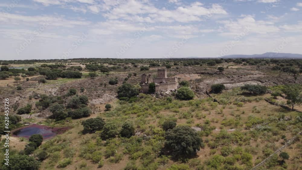 Aerial view circling the hilltop castle of Mayoralgo wilderness in Aldea del Cano province of Cáceres Aerial view circling the hilltop castle of Mayoralgo wilderness in Aldea del Cano province of Cáceres