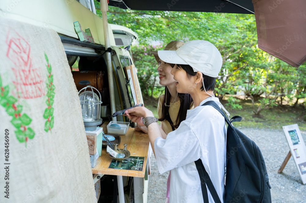 Young women ordering food and drinks from a food truck