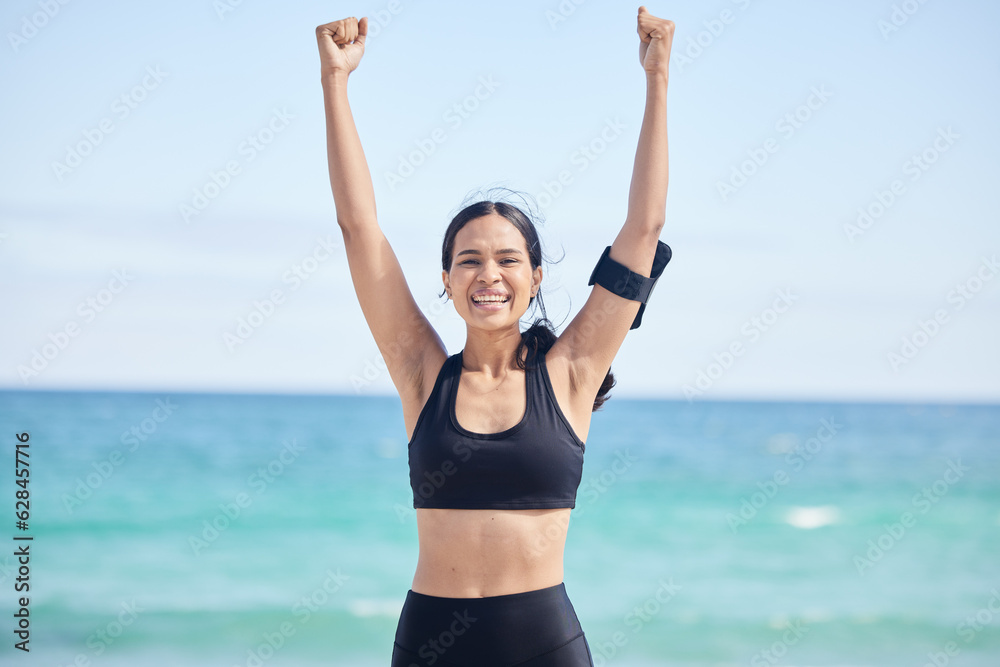 Happy woman, fitness and achievement on beach for winning, workout success or outdoor exercise. Portrait of excited female person in celebration for accomplishment, milestone or training by the ocean Happy woman, fitness and achievement on beach for winning, workout success or outdoor exercise. Portrait of excited female person in celebration for accomplishment, milestone or training by the ocean