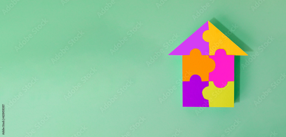 The house is made of puzzles. Family preservation concept The house is made of puzzles. Family preservation concept