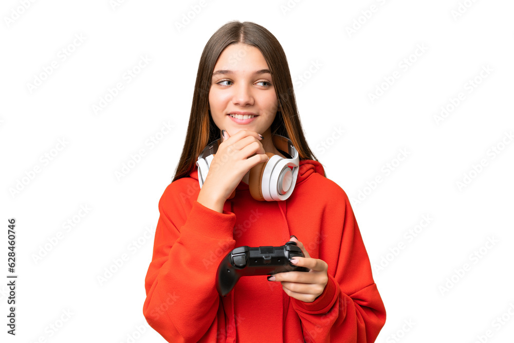 Teenager caucasian girl playing with a video game controller over isolated background looking to the side and smiling Teenager caucasian girl playing with a video game controller over isolated background looking to the side and smiling