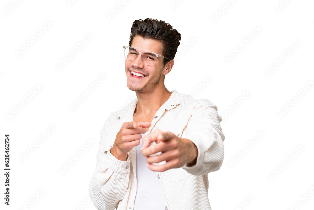 Young handsome caucasian man over isolated background surprised and pointing front Young handsome caucasian man over isolated background surprised and pointing front