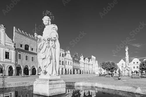 Telč, Czech Republic - 8 July 2023: Saint Margaret fountain and houses on the main square in the of town of Telč in black and white