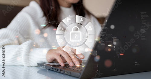 Cybersecurity technology concept. A women is using a computer with data privacy protection from digital threats. Protect system hardware, software and applications Connect to work on the Internet.