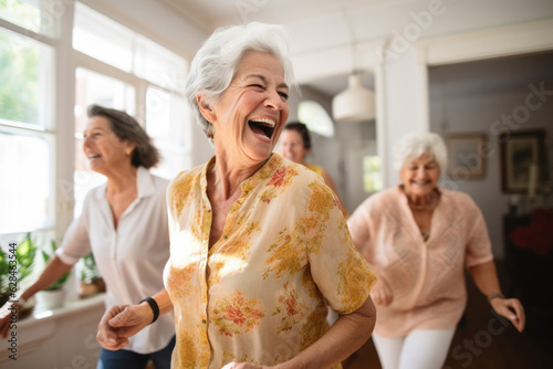 Group of happy active senior women laughing and dancing at home.