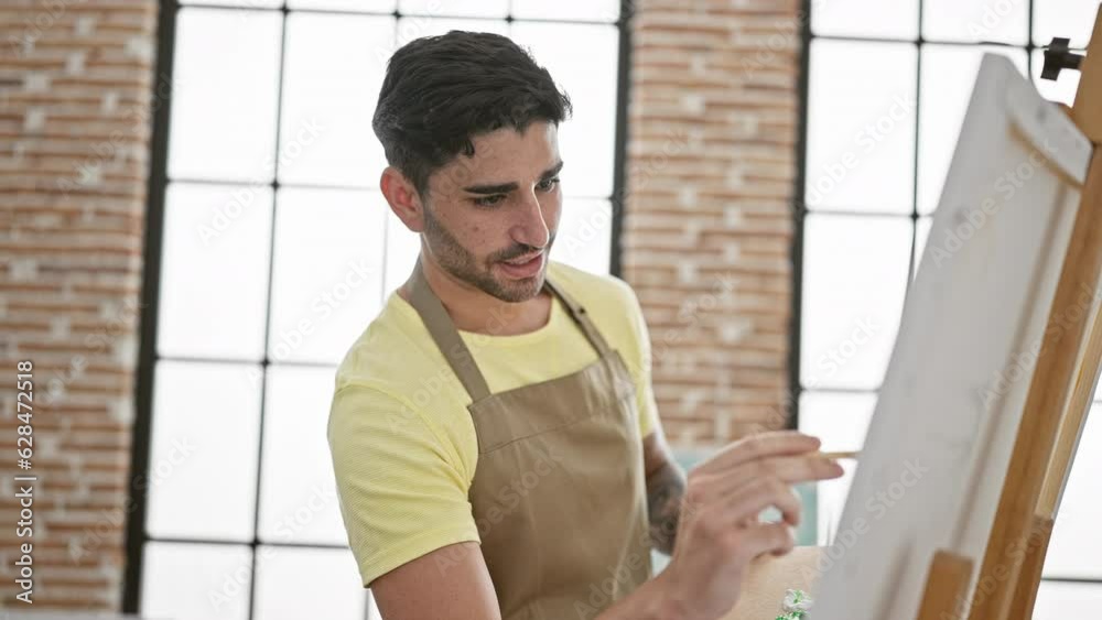 Young hispanic man artist smiling confident drawing at art studio Young hispanic man artist smiling confident drawing at art studio