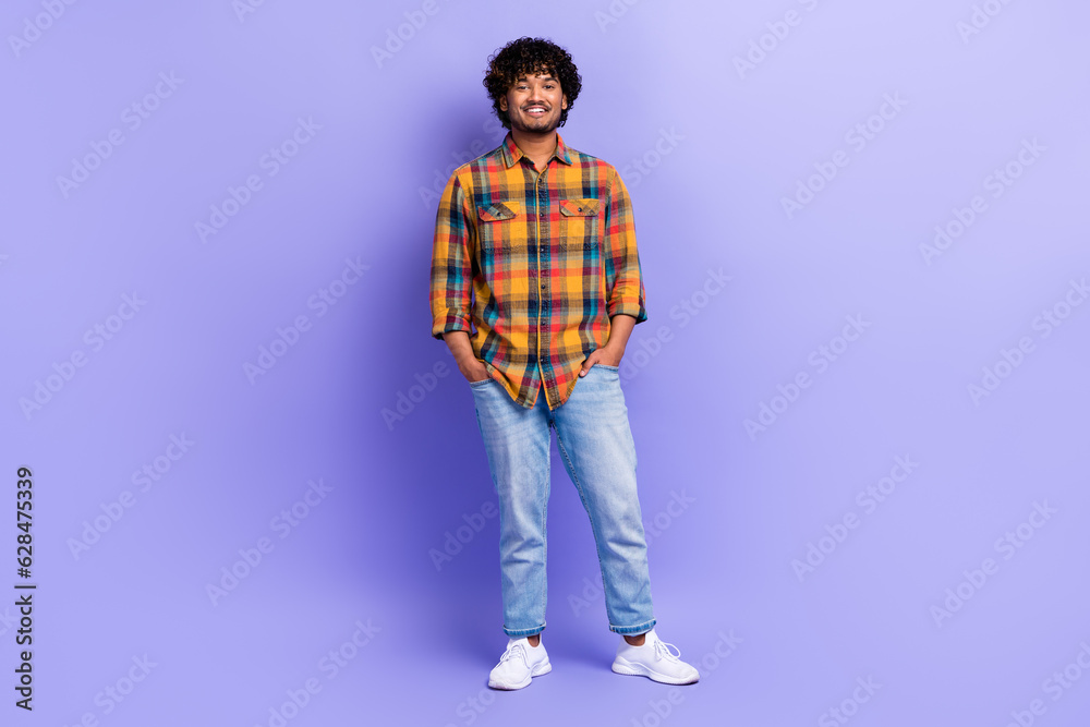 Full size portrait of positive cheerful young person put hands pockets posing isolated on purple color background Full size portrait of positive cheerful young person put hands pockets posing isolated on purple color background