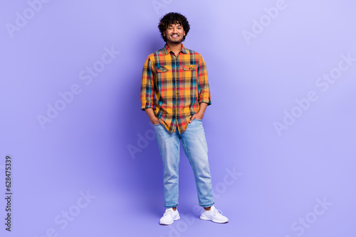 Full size portrait of positive cheerful young person put hands pockets posing isolated on purple color background