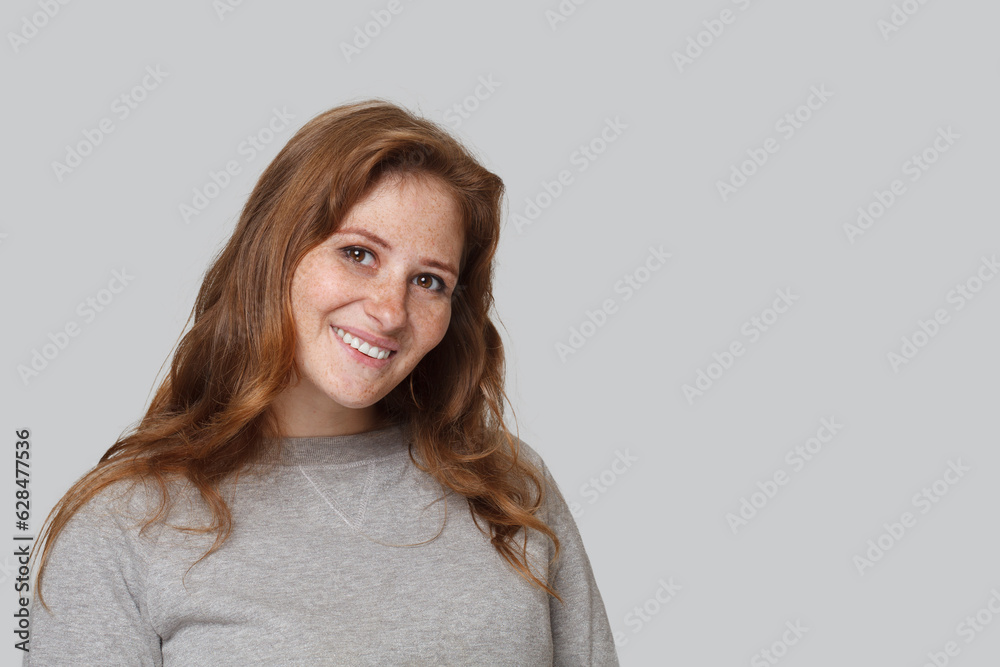 Redhead model woman smiling on white background, studio portrait Redhead model woman smiling on white background, studio portrait