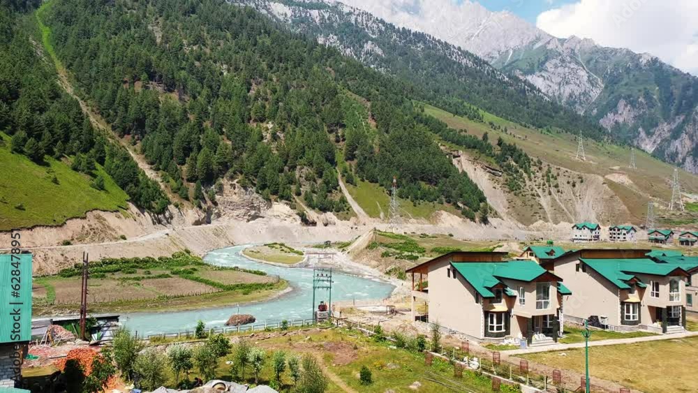 Houses at landscape blue sky mountains forests water roads and greenery in beautiful destination of kashmir.