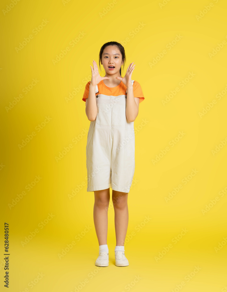 cute asian girl posing on a yellow background cute asian girl posing on a yellow background