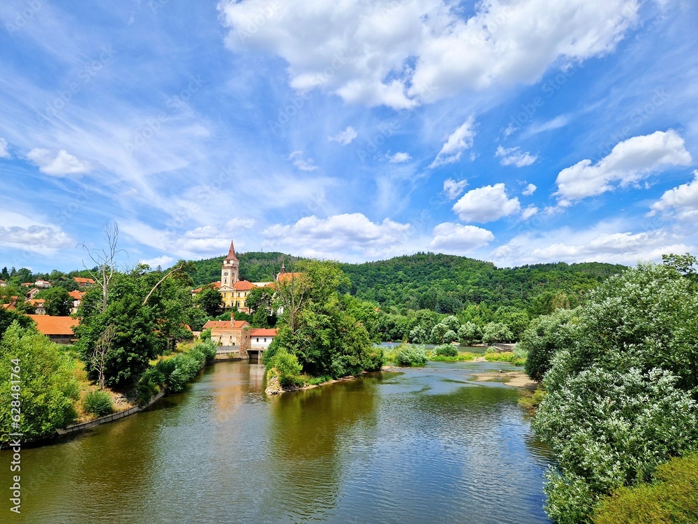 A view of Sazava Monastery and Sazava river under blue sky and white clouds in Sazava town in Central Bohemia, Czech Republic