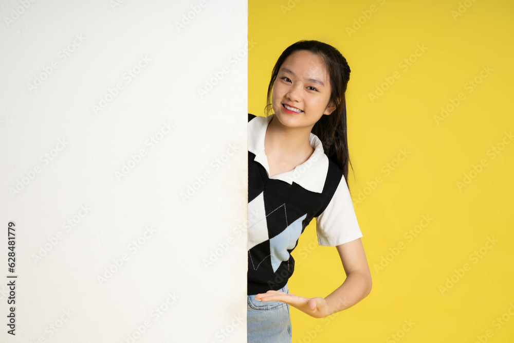 image of asian girl standing with billboard image of asian girl standing with billboard