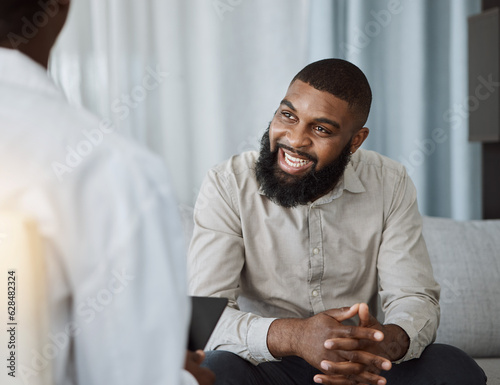 Happy black man, therapist and consultation in meeting for healthcare, mental health or therapy at the hospital. African male person talking to consultant in physiology, counseling or medical help photo