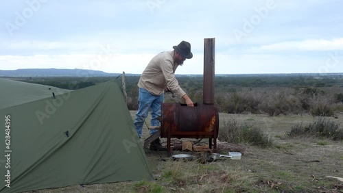 A bushman in the Australian desert making a fire with a an oldschool fire drum. photo