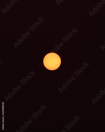 Sunrise with Canada's wildfires: The sun shines through the dust suspended on the black background